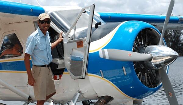 a man standing next to a plane