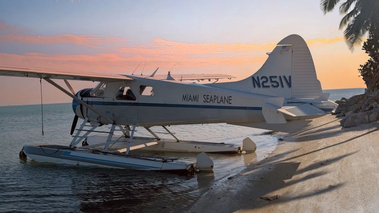 Miami seaplane resting on a tropical beach at sunset. 