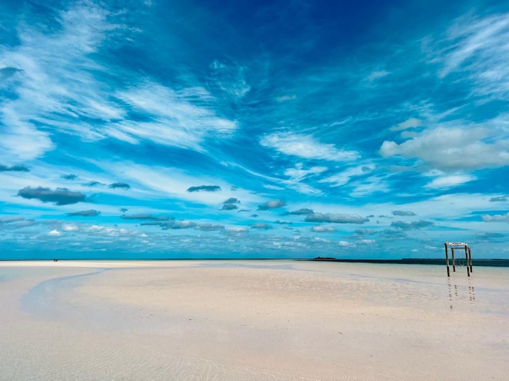 Eleuthera beach with turquoise water, sand, and vivid sky.