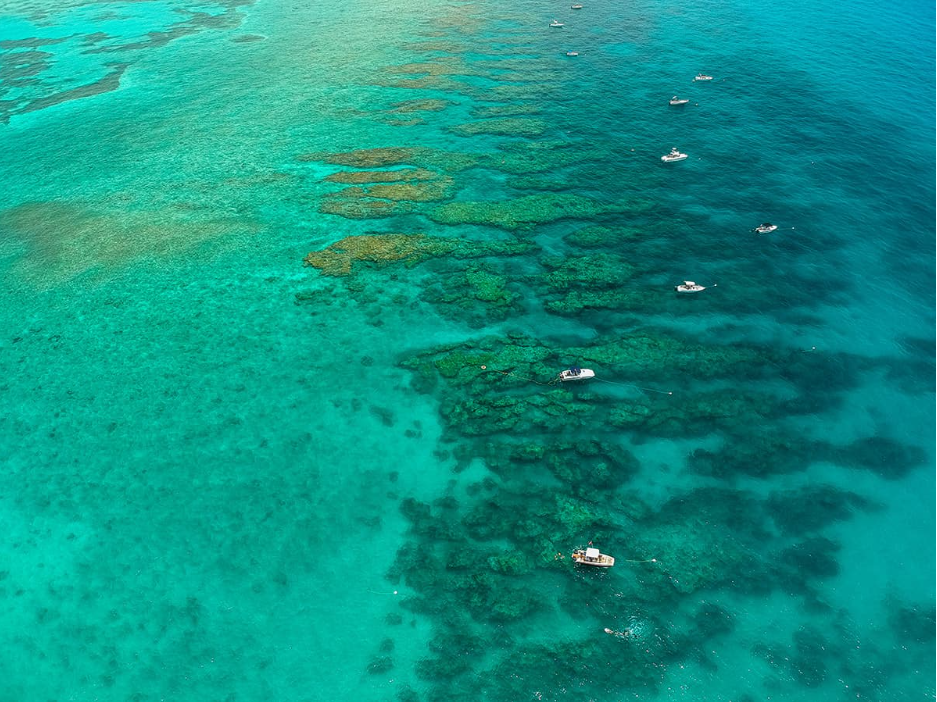 Aerial view of Looe Key Reef with boats over turquoise coral.