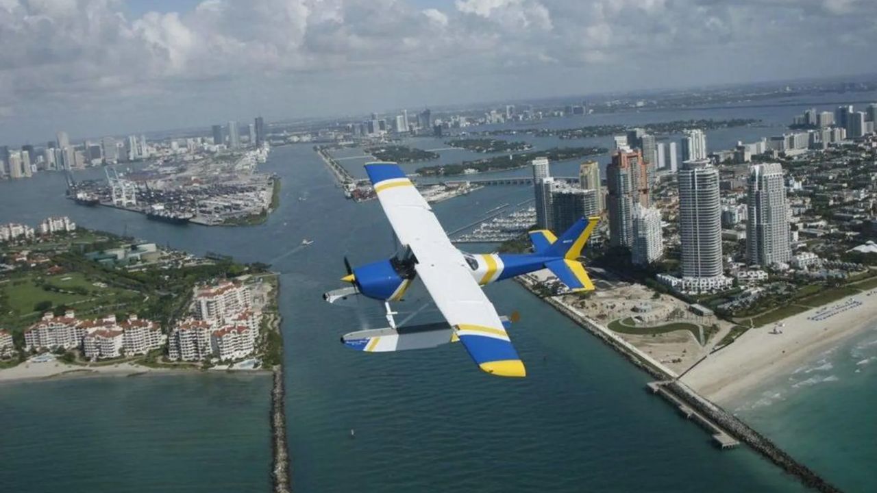 eaplane flying above Miami coastline and Biscayne Bay waterfront.